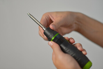 A man changing drill bit in electric screwdriver