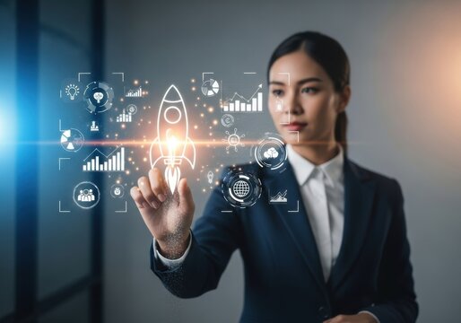 Professional Asian businesswoman interacting with futuristic holographic interface featuring a glowing rocket launch startup concept