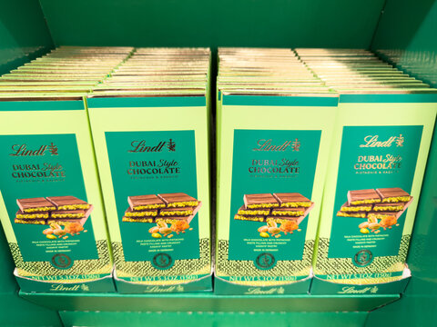 Lindt Pistachio Dark Chocolate Bars Neatly Stacked on Store Shelf