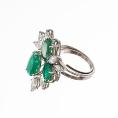 platinum ring with two pear-cut emeralds and one marquise-cut emerald surrounded by nine diamond navettes, isolated on white background