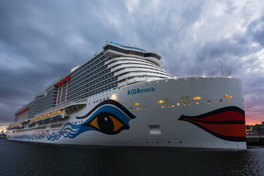 NORWAY - MAY 20, 2025: The 'AIDAnova' cruise ship, operated by AIDA Cruises, is seen docked in a Norwegian port under a dramatic, cloudy sky at dusk.