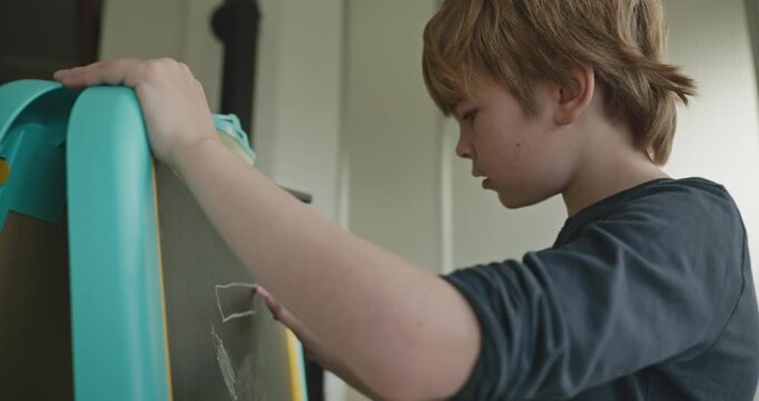 Boy Kid Draws With Chalk on Blackboard at Home 4K 10-bit