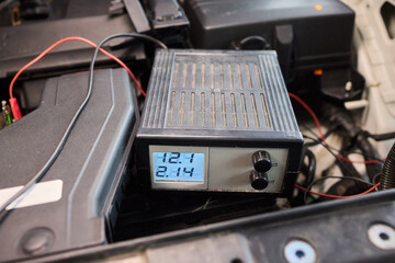 Fototapeta premium Technician analyzing amplifier during workshop inspection, Audio technician conducting diagnostic analysis of car stereo system under laboratory lighting conditions