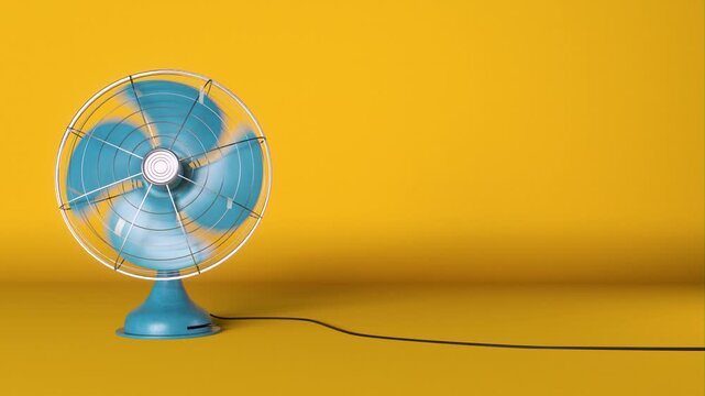 Retro blue electric fan spins and blows air on a bright yellow background creating summer atmosphere