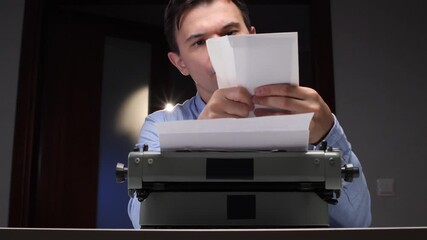 Man reading a letter, holding it above an old mechanical typewriter with paper, immersing himself in the written message from a bygone era of thoughtful communication