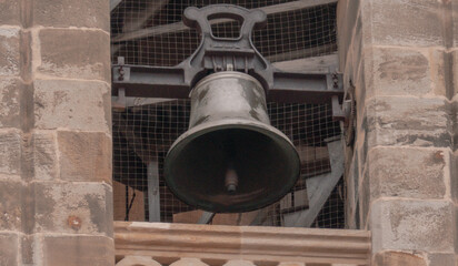 Church bell inside historic stone bell tower in Vitoria-Gasteiz old town, Basque Country, Spain — religious architecture detail.
