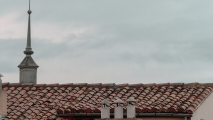 Church spire above traditional rooftops in Vitoria-Gasteiz old town, Basque Country, Spain — classic European skyline.
