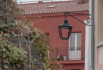 Traditional street lantern on historic building facade in Vitoria-Gasteiz old town, Basque Country, Spain — quiet European city detail.