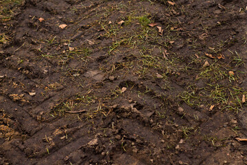 Pattern of tractor tire track imprint in dirt road dried muddy ground, top view