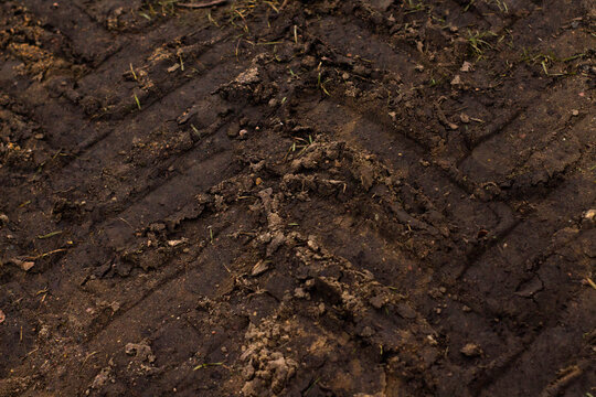 Pattern of tractor tire track imprint in dirt road dried muddy ground, top view