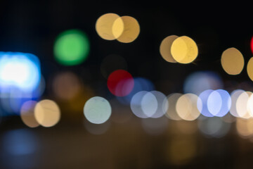 abstract night city lights and vibrant bokeh circles creating a magical, dreamy urban atmosphere. blurred traffic and luminous glow