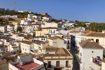 Unique whitewashed village built into dramatic rock formations, offers one of Andalusia’s most picturesque sights in Setenil de las Bodegas, Spain