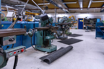 laboratory space comprising range of milling equipment alongside neatly organized hand and power