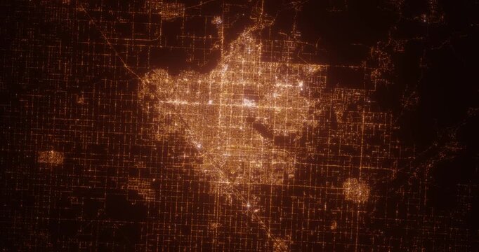 Fresno (California, USA) aerial view at night. Top view on city from space. Camera is zooming in, rotating clockwise