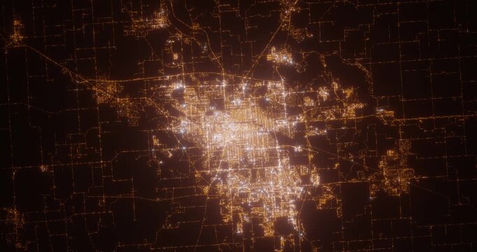 Springfield (Illinois, USA) aerial view at night. Top view on modern city with street lights. Camera is zooming out, rotating counterclockwise. Vertical video. The north is on the left side