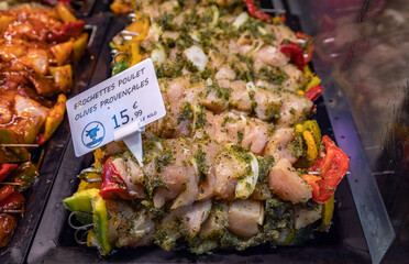 Chicken provencal skewers at a French butcher shop counter, Nice, South of France