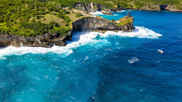 Drone shot of dramatic cliffs and ocean with manta rays at Nusa Penida, Indonesia