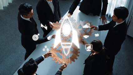 A diverse team of professionals collaborates on innovative business strategies, using gears and a rocket symbol to symbolize growth and success in a modern office setting. Raster