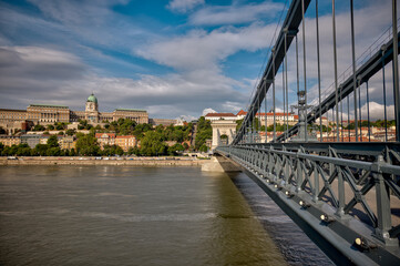 Fototapeta premium Budapest, Hungary - July 27, 2025: Detailed views of the Széchenyi Chain Bridge with its steel structure, rivets, and ornate lamps spanning the Danube River 