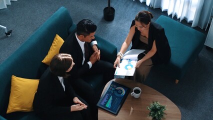 Top view of professional business team analyze financial graph at meeting room while smart project manager walking in to room and present stock market investment chart. Creative business. Directorate.