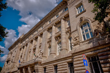 Budapest, Hungary - July 27, 2025: Ornate Neo-Baroque and Neo-Renaissance architectural details on the facade of a historic building in central Budapest. The decorative stone carvings, columns, and sy