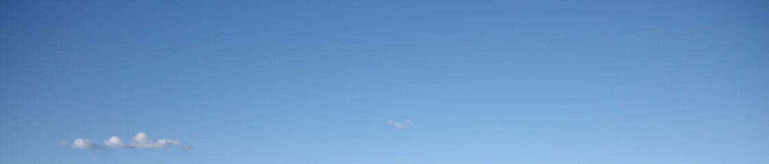 clear gradient blue sky with single floating cloud background with blank space