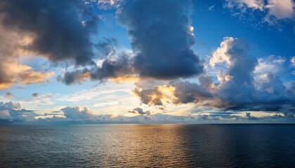 Sky Replacement Of Blue Sky And Puffy White And Gray Clouds Far In The Horizon Over A Large Body Of Water At Sunset
