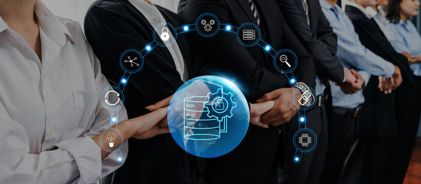 A diverse business team collaborating in an office setting, showcasing technology and innovation through digital icons emphasizing data management and teamwork. Trope