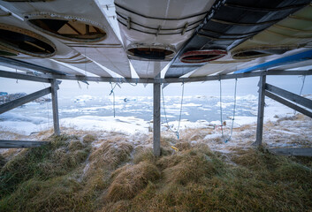 Traditional greenlandic kayaks in the city of Ilulissat, Greenland, on a cold day of late autumn © Petr
