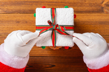Santa Claus unboxing a present box at horizontal composition