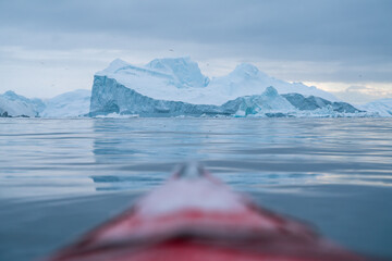 Giant icebergs floating in Ilulisat icefjord, Greenland. Massive icebergs, calved from the Sermeq Kujalleq Glacier, float through the Ilulissat Icefjord in western Greenland viewed from the kayak © Petr