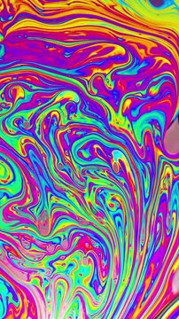 Macro shot of a soap bubble creates a colorful and psychedelic background