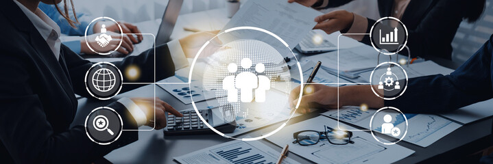 Business teamwork connected around a globe representing cooperation, leadership, and organizational...