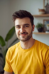 Warm natural portrait of a young man smiling confidently indoors, surrounded by soft daylight and subtle home d&eacute;cor details, highlighting an approachable expression and relaxed atmosphere suitable for
