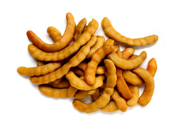 Sweet preserved tamarinds on white background.