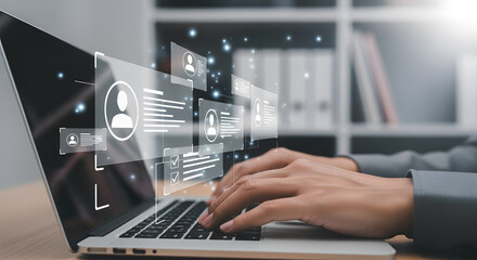 Professional hands actively typing on a laptop displaying futuristic human resource data visualization with glowing particles