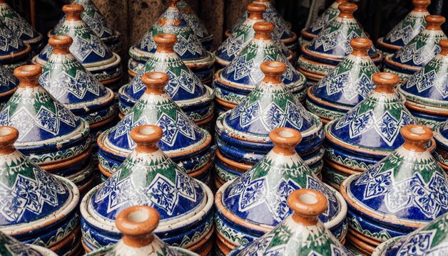 Colorful ceramic tagines arranged in an artisan market showcasing Moroccan craftsmanship Generative AI - Powered by Adobe