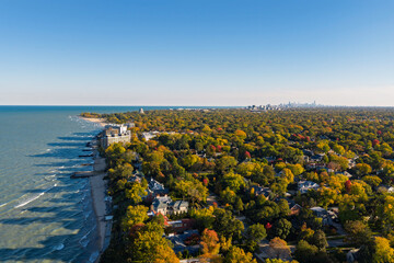 Chicago Northshore suburbs in autumn, colorful trees in residential area by the Lake Michigan, city downtown on the horizon