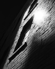 Nighttime brick wall with window and light