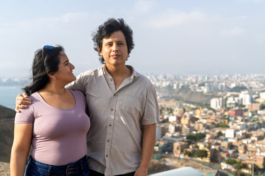 Young couple enjoying city view at viewpoint - Powered by Adobe