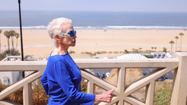 Senior woman gets her morning exercise at a park overlooking the Santa Monica beach.