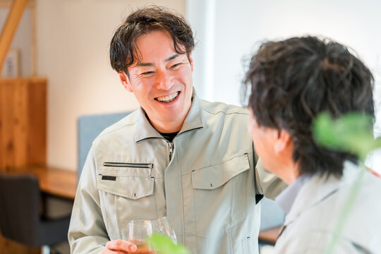 Businessmen in work clothes holding champagne and lining up in the office (teamwork, rally, victory party, celebration)
