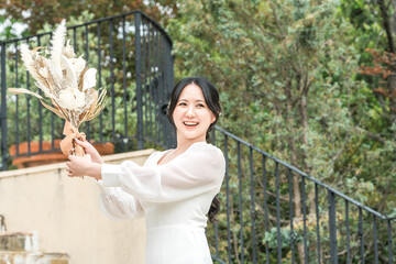 Bride and woman tossing bouquet at wedding

