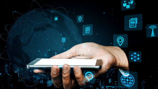 A hand holding a smartphone surrounded by digital icons and a globe, symbolizing the integration of technology in communication and information exchange. Xenic