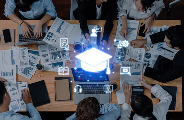 A diverse team interacts around a table, analyzing educational data while incorporating digital icons that symbolize online learning and technological advancement. Trope