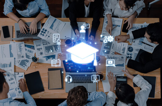 A diverse team interacts around a table, analyzing educational data while incorporating digital icons that symbolize online learning and technological advancement. Trope