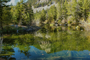 Reflection on Wild Bill Lake in Autumn above Red Lodge Montana in Custer National Forest.