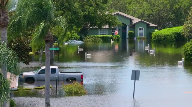 Hurricane Debby tropical rainstorm flooded cars and residential homes in suburban community in Sarasota, Florida. Aftermath of natural disaster