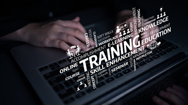 Close-up view of hands typing on a laptop with various words related to training and professional development, emphasizing learning and skill enhancement through digital education. Tessel