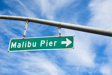 Street sign pointing the direction to Malibu Beach Pier along the Pacific Coast Highway in Los Angeles County, Southern California. 